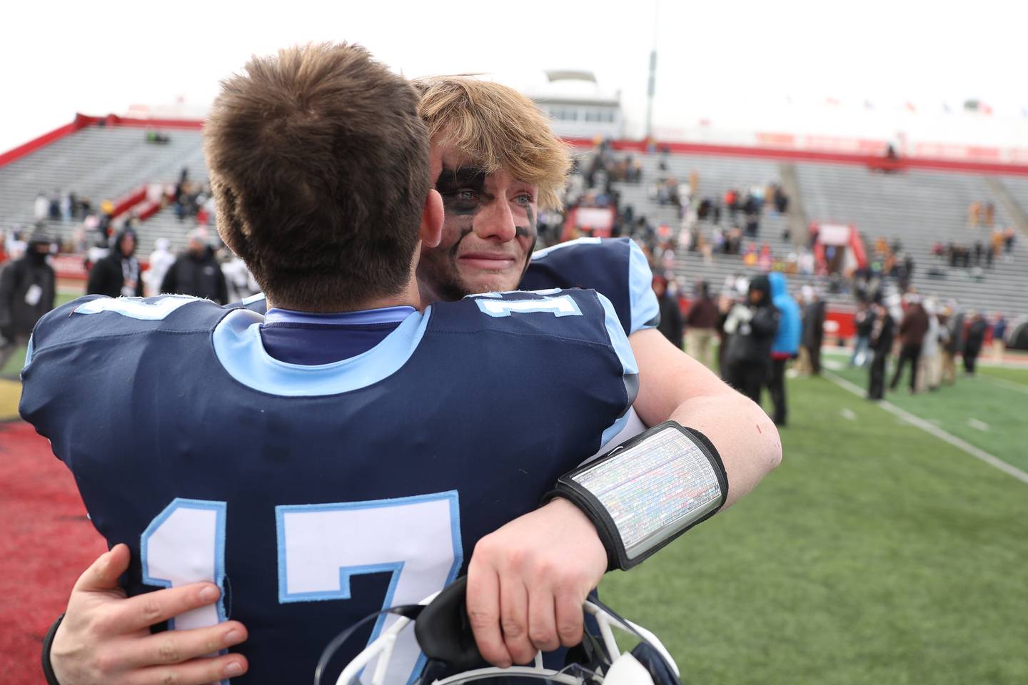 An emotional Logan Malachuk hugs his teammate Richards Skinkis after Nazareth defeated Joliet Catholic in the Class 5A state championship on Saturday, Nov. 30, 2024 in Normal.