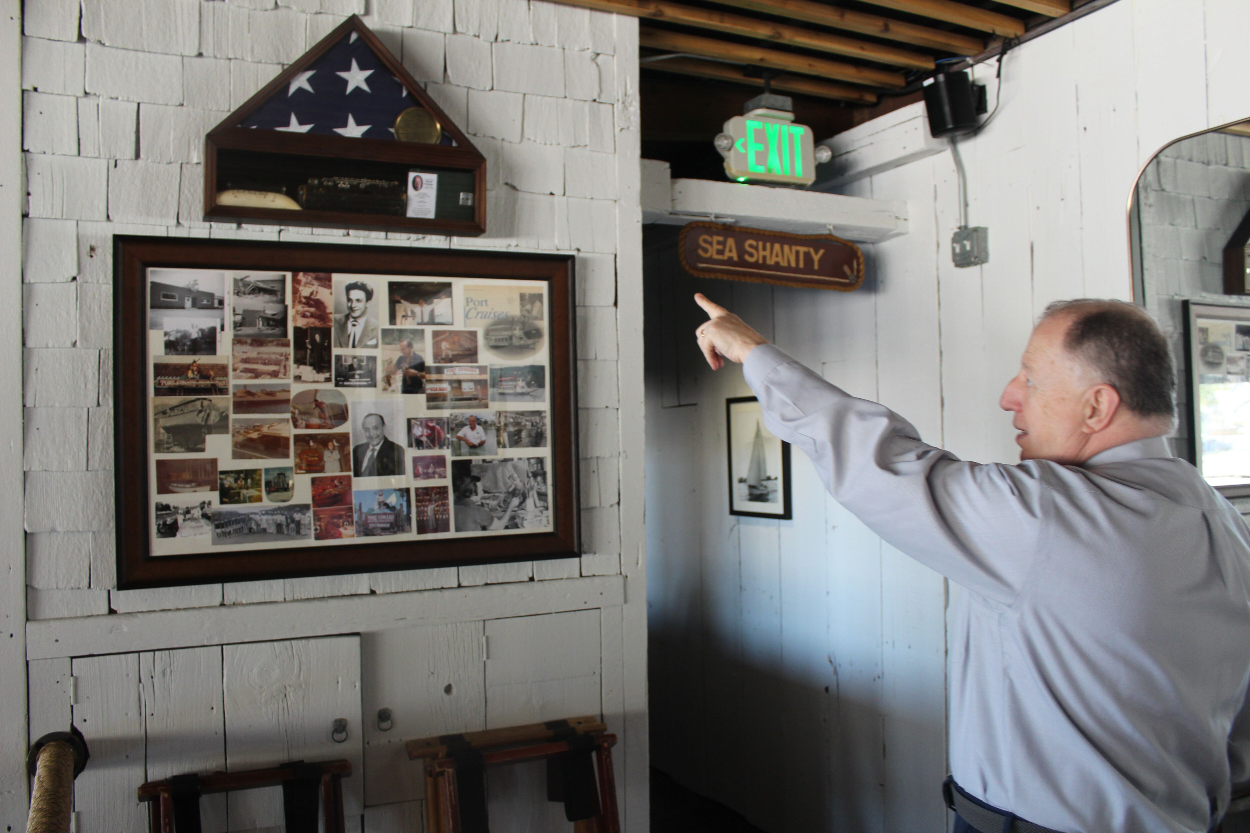 Port Edward owner Ziya Senturk shows off pictures and history of late founder Ed Wolowiec.