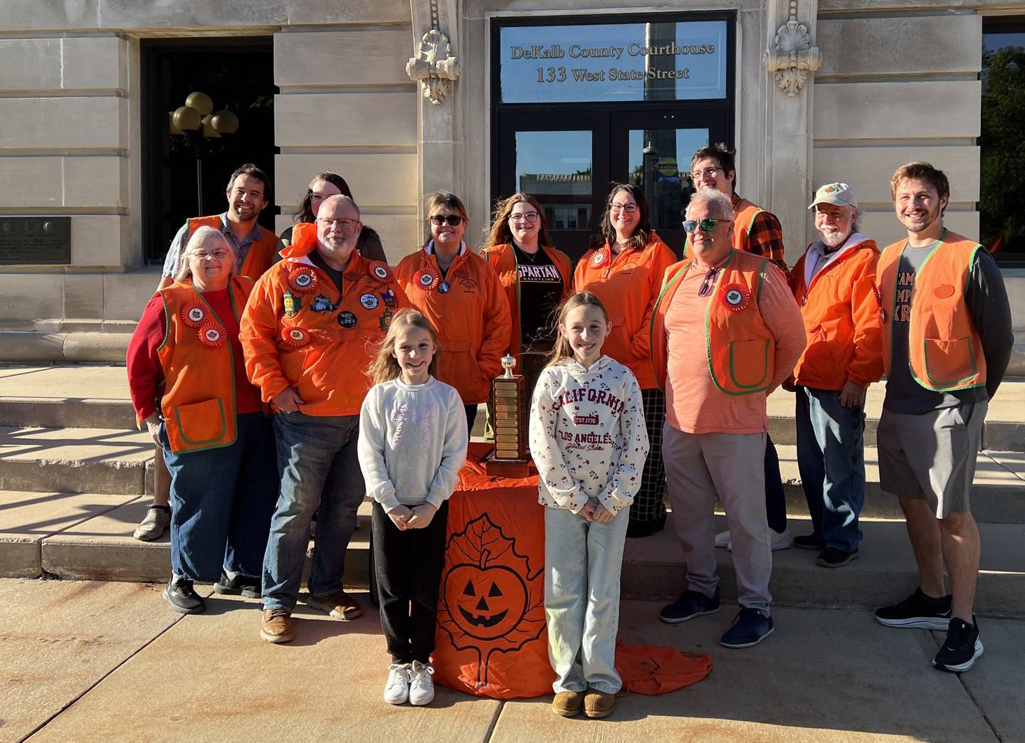 Rayna and Annabelle Hochstatter stand with the Sycamore Pumpkin Festival committee on May 20, 2026, after being announced as winners of the festival's annual theme contest.