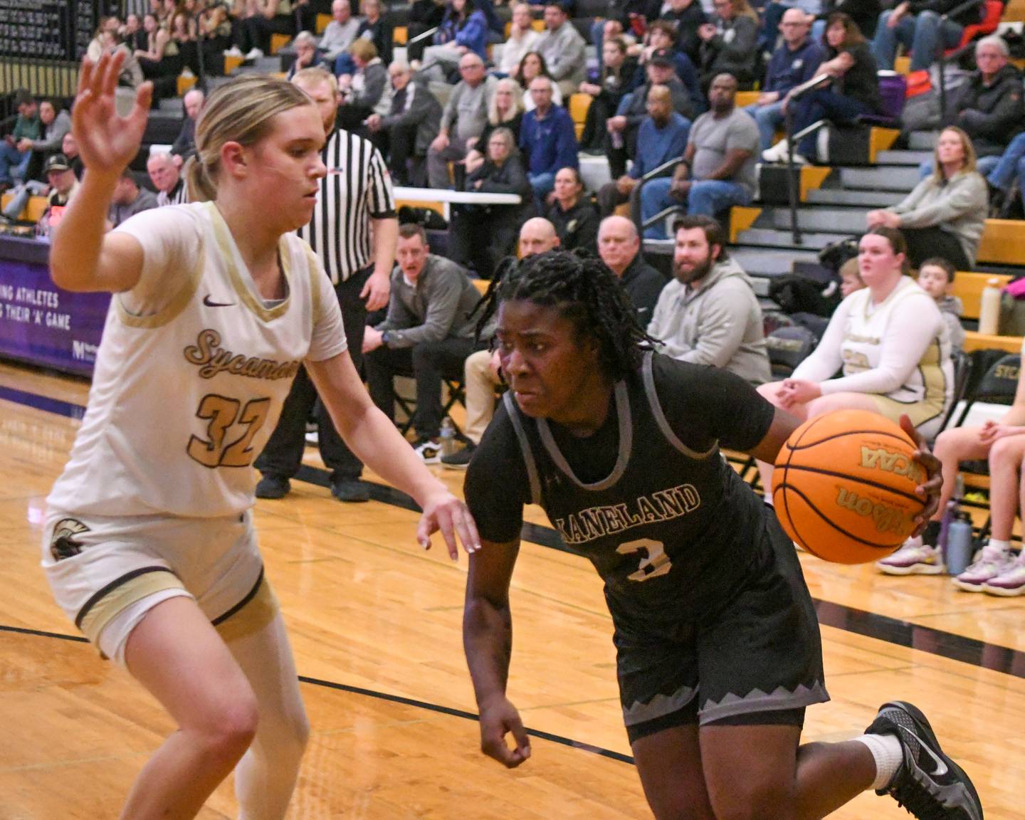 Kaneland's Amani Meeks (3) tries to the basket while being defended by Sycamore's Quinn Carrier (32) during the game on Monday Feb. 10, 2025, held at Sycamore High School.
