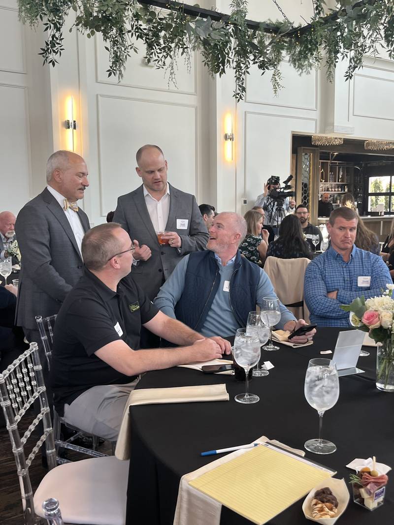 Plainfield Mayor John F. Argoudelis (left) speaks with attendees at the annual State of the Village address hosted by the Plainfield Junior Woman’s Club at Plainfield Farmhouse on March 12, 2025.