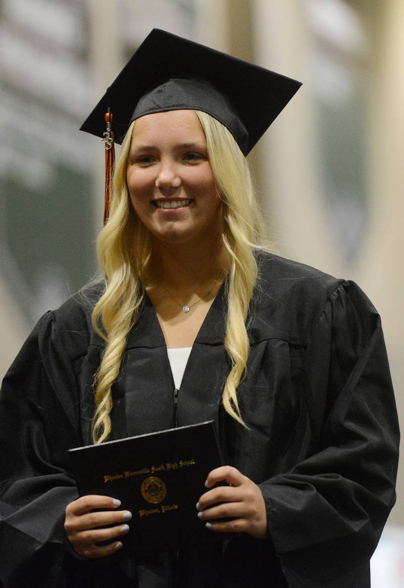 Joe Lewnard/jlewnard@dailyherald.com
A graduate holds her diploma during the Wheaton Warrenville South High School graduation, held at the College of Dupage in Glen Ellyn Saturday.