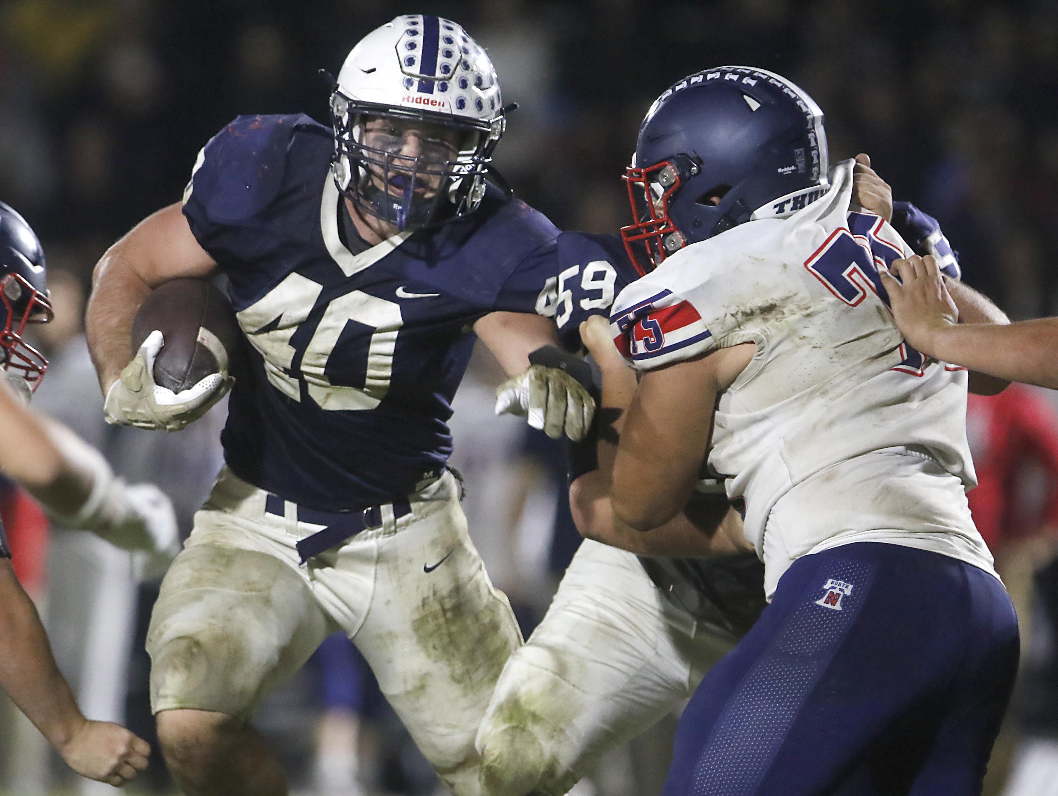 Cary-Grove's Logan Abrams fights for running room during an IHSA Class 5A quarterfinal playoff football game against Belvidere North on Friday, November 14, 2025, at Cary-Grove High School, in Cary.