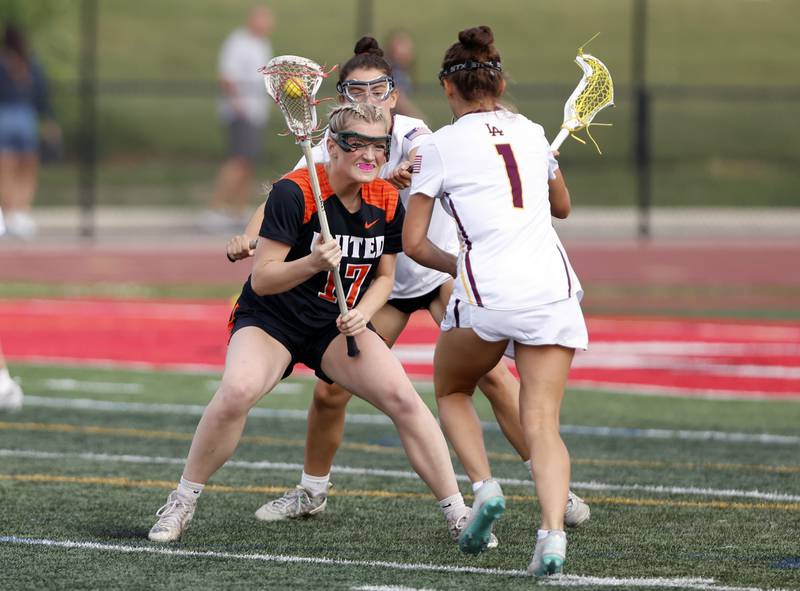 Crystal Lake Central Coop's Ella Trudeau (17) attempts to get past the Loyola Academy defense during the lacrosse state semi-final match between Crystal Lake Central and Loyola Academy on Thursday, June 5, 2025 in Hinsdale.