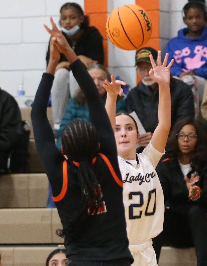 Marquette's Kaitlyn Davis shoots a jump shot over Peoria Manual's Ma'Kya Maxwell during the Falcon-Irish Thanksgiving Tournament on Monday, Nov. 18, 2024 at Flanagan High School.