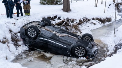 Person hospitalized with possible hypothermia after rollover crash into water near Elgin