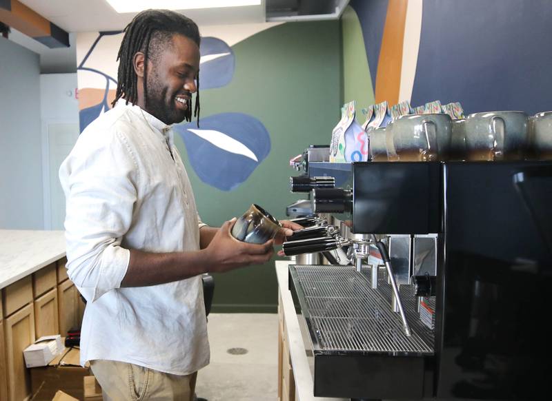 Troy Rorer, owner of The Greenhouse with his wife Kailey, sets up their new coffee bar Thursday, Feb. 29, 2024, at the store in Sycamore. The Greenhouse has expanded in size and will soon offer new services.