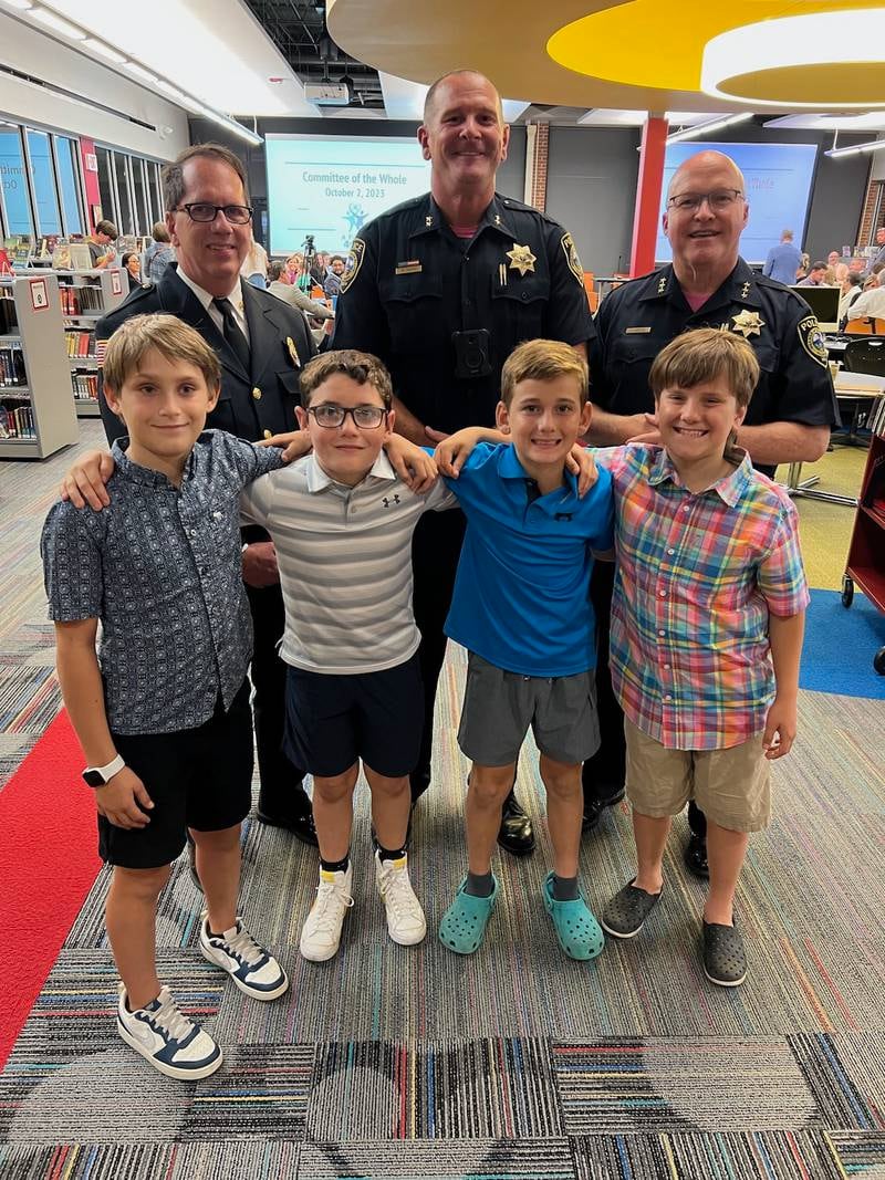 Glen Ellyn Fire Chief Chris Clark, Deputy Police Chief Kurt Vavra and Police Chief Philip Norton honored four quick-thinking students credited with saving a man from drowning.