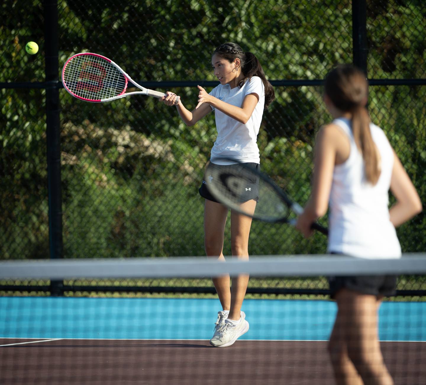 Kankakee's Mishelle Gaytan makes a return hit in a doubles match against Bradley-Bourbonnais on Wednesday, September 10, 2025.