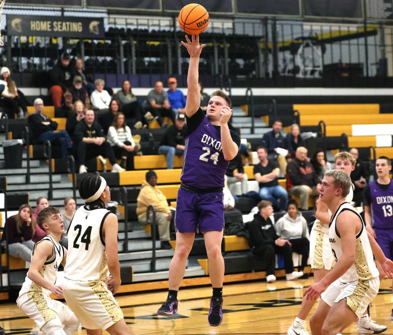 Dixon’s Eli Davidson shoots in the paint surrounded by Sycamore defenders during their game Tuesday, Jan. 14, 2025, at Sycamore High School.