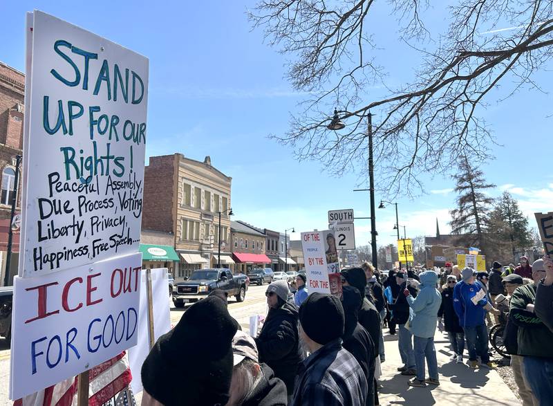 People line the sidewalk along state Route 2 in downtown Oregon, Illinois, during the No Kings rally organized by Indivisible of Ogle County on Saturday, March 28, 2026. The 2-hour afternoon event drew an estimated crowd of 650 around the sidewalks of the Ogle County Courthouse.