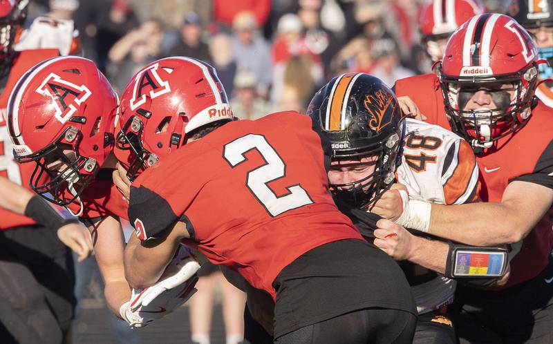 Amboy’s Colt McCoy (lef) runs the ball against Milledgeville’s Spencer Nye Saturday, Nov. 15, 2025, in the 8-man football semifinal.
