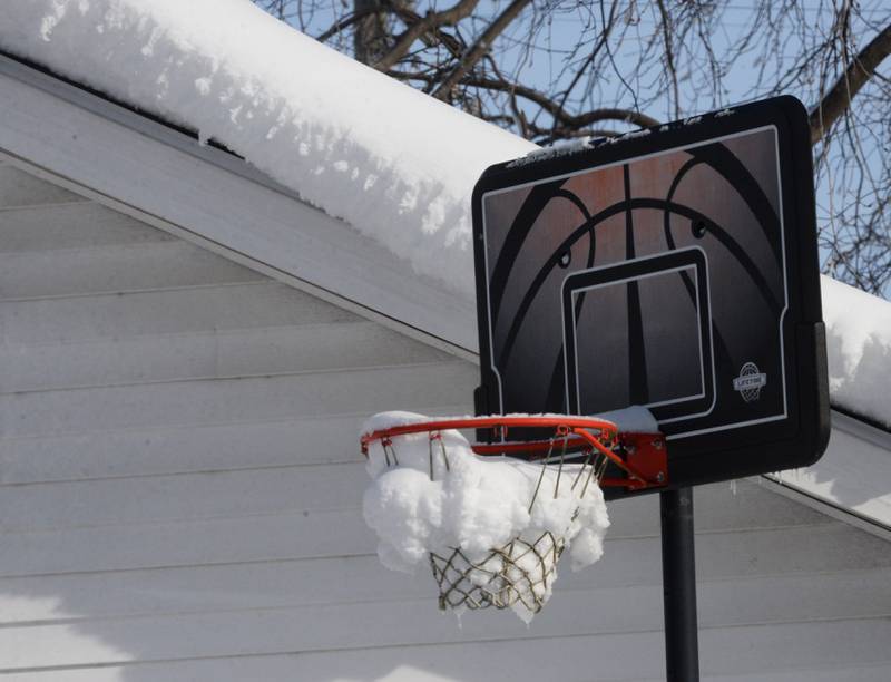 A frozen basketballl hoop in Forreston is filled with snow and ice on Monday, Jan. 15, 2024 following Friday and Saturday's winter storm that dropped an estimated 10-12 inches of snow across the region. Frigid temperatures followed the snow with nighttime lows falling to -14.