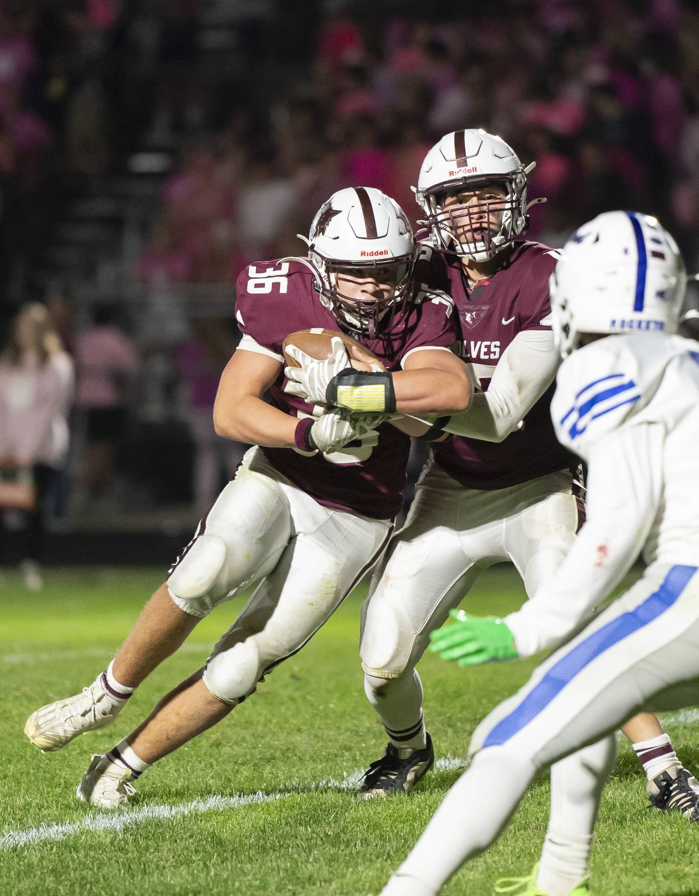 Prairie Ridge quarterback Owen Satterlee hands off the ball to Giovanni Creatore (36) during their Fox Valley Conference game against Burlington Central on Friday, October 11, 2024 at Prairie Ridge High School in Crystal Lake. Ryan Rayburn for Shaw Local