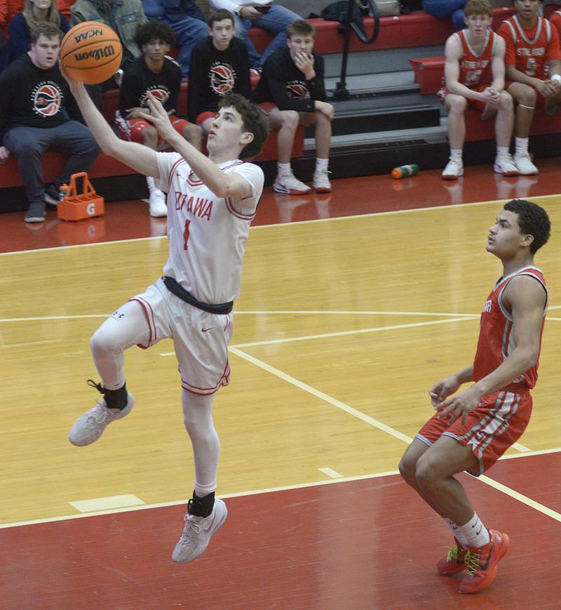 Ottawa’s Colt Bryson gets past Streator’s Layzeric Moton for a layup in the 2nd period Saturday at Ottawa.