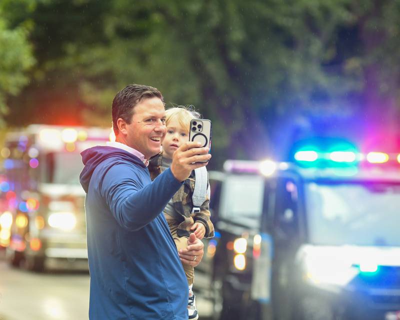 Ryan Anetsberger holds his son Brooks Anetsberger, 2, of Glen Ellyn while taking a selfie while the Glen Ellyn fire department passes on Saturday Sept. 28, 2024, during the Glenbard West homecoming parade that traveled down Main Street to Glenbard West High School.