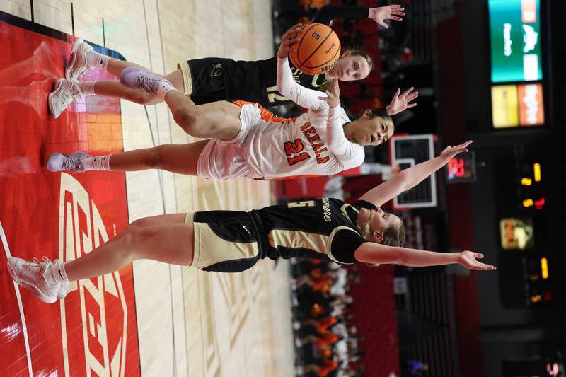 DeKalb's Alicia Johnson goes between Sycamore's Grace Amptmann Friday, Jan. 30, 2026, during their game in the FNBO Challenge in the Convocation Center at Northern Illinois University in DeKalb.