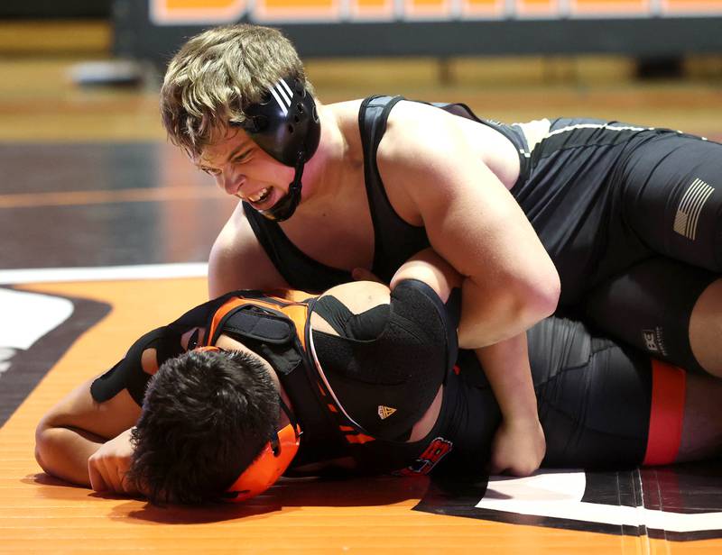 Sycamore’s Clyde Nott tries to turn DeKalb’s Erick Rivas Friday, Jan. 17, 2025, during their 215 pound match at DeKalb High School.
