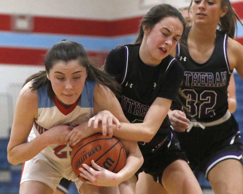 Marian Central's Kiara Kelly and Rockford Lutheran's Kaylee Bankes battle for a rebound during a non-conference girls basketball game Monday, Dec. 12, 2022, between Marian Central and Rockford Lutheran at Marian Central Catholic High School, in Woodstock.