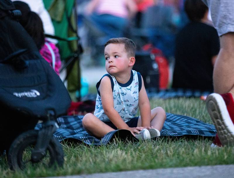 Colton Aiello, 3, patiently waits for fireworks to begin during North Aurora's annual Independence Day celebration at Riverfront Park in North Aurora on Monday, July 3, 2023.