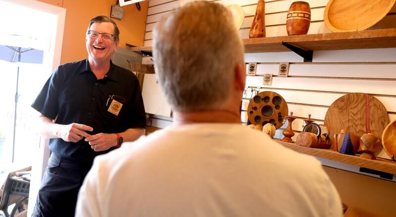 Rich Hall-Reppen talks with customers at Fox Valley Gallery of Wood during opening day of the Batavia Boardwalk Shops on Friday, May 20, 2022. All businesses are open Fridays, Saturdays, and Sundays through December 18, 2022
