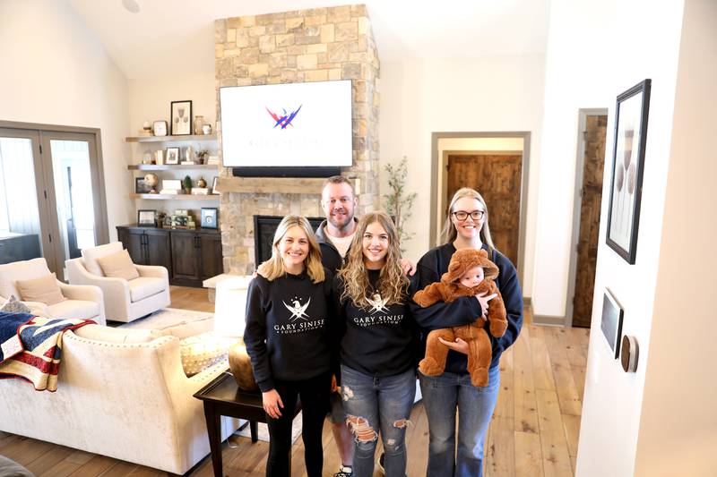 Retired U.S. Army Chief Warrant Officer 2 Patrick Scrogin, along with wife Alexa (left) and children Kaylee, Paige and Wyatt photographed in the family’s newly constructed, specially adapted smart home in St. Charles on Thursday, Jan. 18, 2024. The mortgage-free home was made possible by the Gary Sinise Foundation.