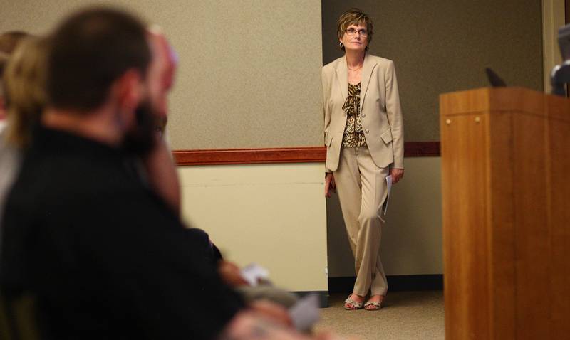 Presiding Judge Robbin Stuckert, the judge for the DeKalb County Drug/DUI court, watches the court's graduation ceremony from the side of a conference room in Kishwaukee Community Hospital on Friday, June 8, 2012.