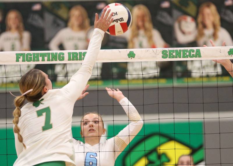 Seneca's Audry McNabb sends a spike past Marquette's Ava Offerman on Thursday, Sept. 19, 2024 at Seneca High School.