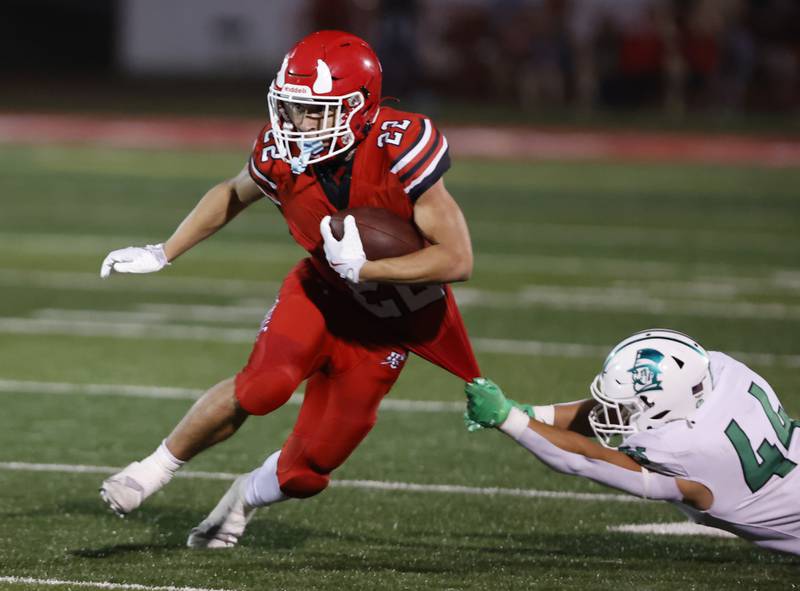 York's Tommy Hosler (44) grabs Hinsdale Central's Dominic Tressler (22) during the varsity football game between York and Hinsdale Central on Friday, Oct. 3, 2025 in Hinsdale, IL.