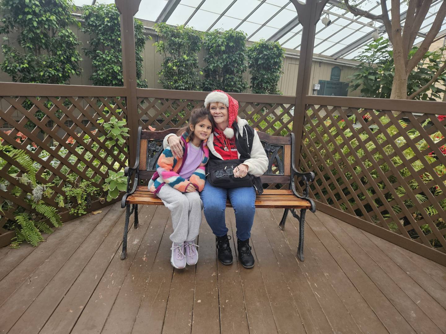 Claudia Munoz of Joliet takes a break from exploring the Bird Haven Greenhouse in Joliet to rest and hug her granddaughter Maizy. Munoz has metastatic breast cancer and wants to give her family happy memories of their time together.