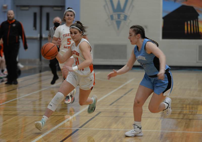 St. Charles East's Torrie Kortan makes her way down court  during their regional game against Willowbrook Thursday Feb. 17, 2022.