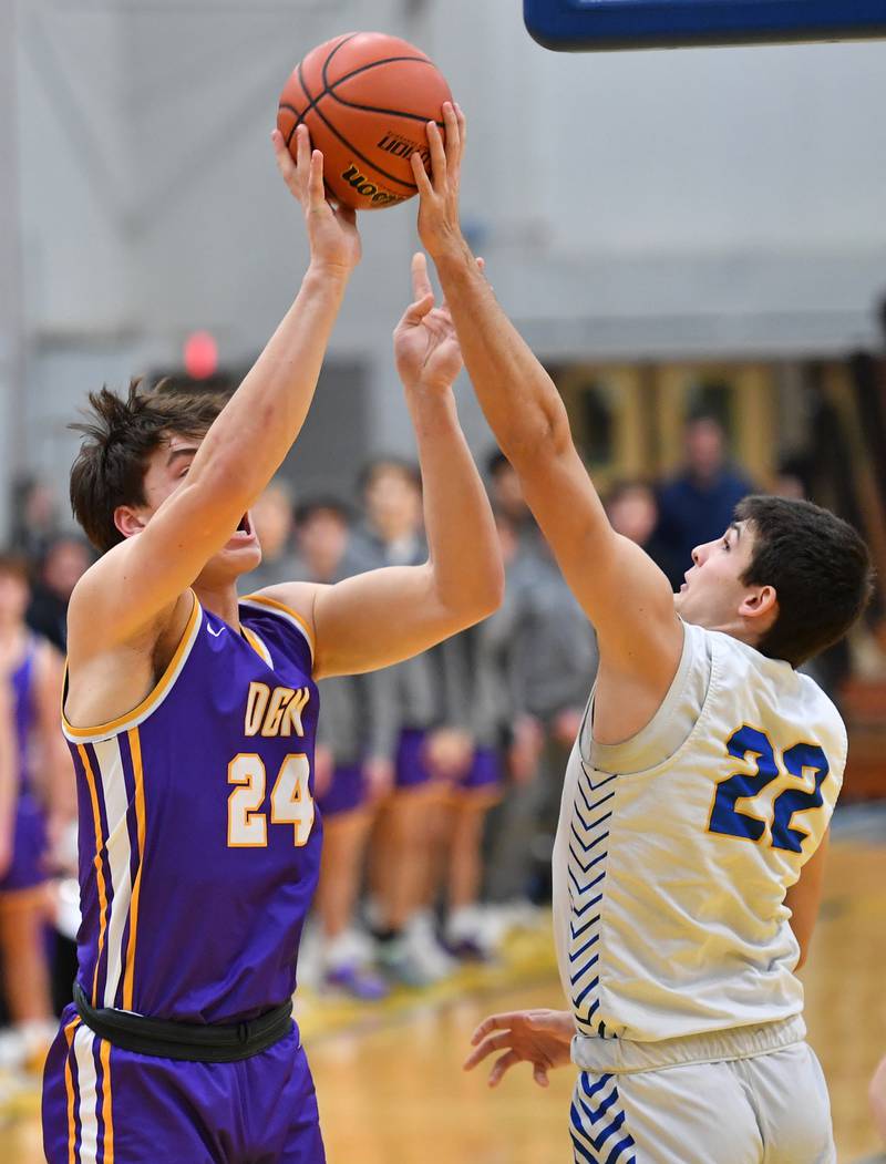 Lyons Township's Carter Reid (22) blocks a shot by Downers Grove North's George Wolkow during a game on Jan. 6, 2023 at Lyons Township High School in LaGrange.