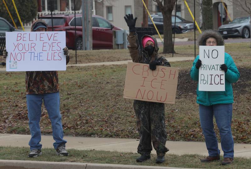 Protesters hold signs during a "ICE Out For Good" protest on Saturday, Jan. 10, 2026 at Rotary Park in Princeton. The Bureau County Democrats organized the event. About two-dozen protesters gathered to protest the ICE officer who shot and killed Renee Nicole Good in Minneapolis on Jan. 7.