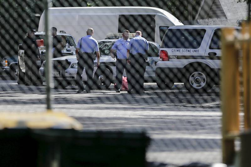 Joliet police officers talk outside the scene of a fatal stabbing at the Evergreen Terrace apartment complex on Wednesday. The family of the 20-year-old woman found stabbed said they are shocked at the account of how she died.