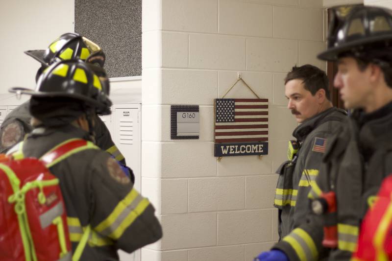 Firefighters inside Joliet West High School on Tuesday, March 25, 2025, for a staged emergency drill simulating the aftermath of a gas explosion.