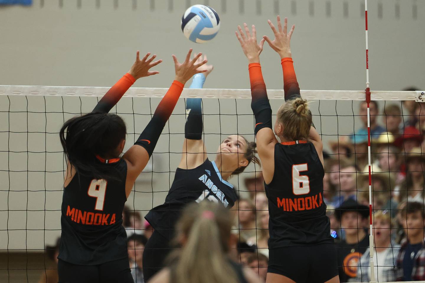 Joliet Catholic’s Ellie Blotnik hits a shot over the arms of Minooka’s defense on Wednesday, Aug. 30, 2023 in Joliet.