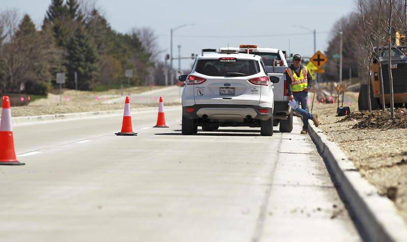 A worker takes a break April 23 from construction on the Longmeadow Parkway in Algonquin between Randall Road and Karen Drive.
