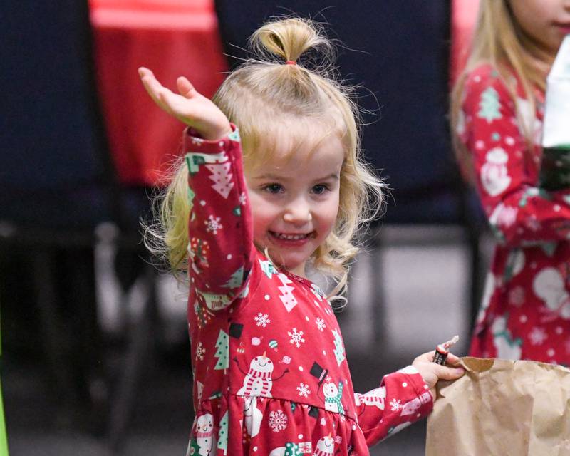 Olivia Holmgren, 3, of La Grange smiles and waves goodbye to Santa before leaving the breakfast with Santa event on Sunday Dec. 15, 2024, held at the La Grange Park District Recreation Center.