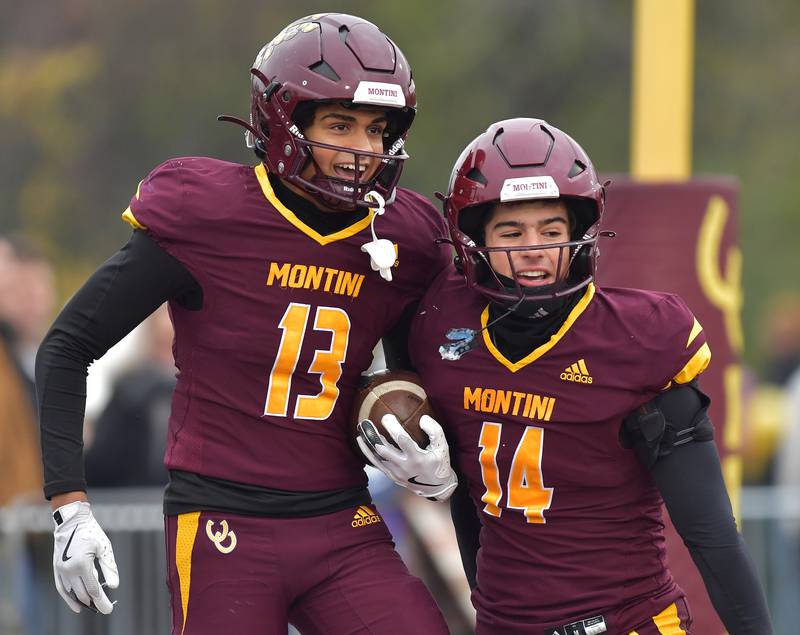 Montini's Cristian Harkins (13) and Nico Castaldo celebrate Harkins touchdown against Wilmington during a Class 3A semifinal game on November 23, 2024 at Montini Catholic High School in Lombard.