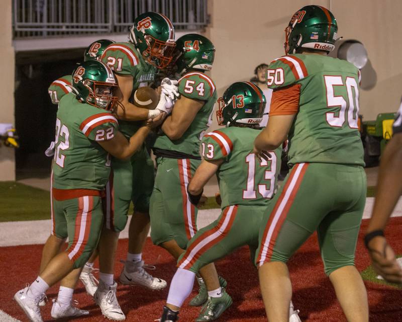 Members of the L-P football team celebrate a touchdown scored by Josh Senica during the game at Howard Fellows Stadium against Woodstock North on Sept. 8, 2023.