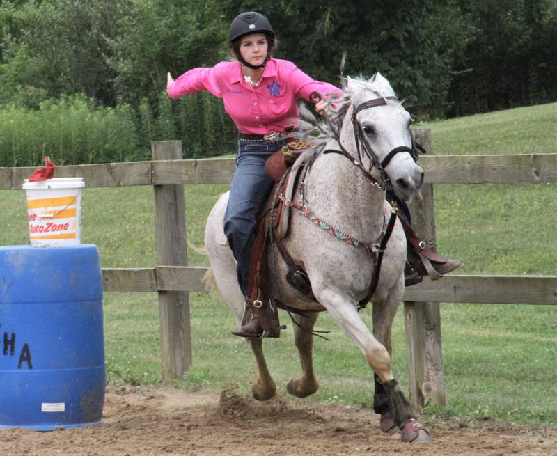 Lilianna Casbarian of Montgomery finishes strong after she sticks the flag during the Kendall County 4-H horse show in July at Harris Forest Preserve.
