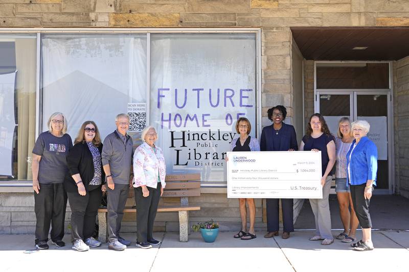 U.S. Rep. Lauren Underwood (fourth from right), D-Naperville, visited Hinckley on Monday, July 1, 2024, to help mark the library’s new downtown move, bolstered by more than $1 million in federal funding secured with the congresswoman’s help. Underwood poses next to library officials in downtown Hinckley at the future location of the library, 142 W. Lincoln Ave.