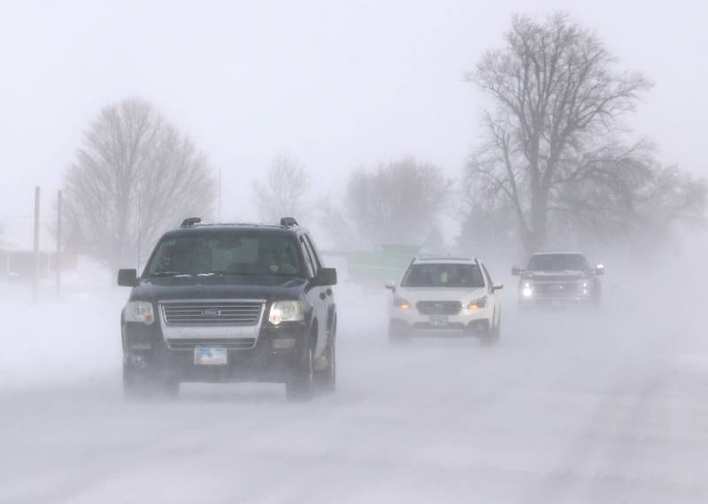 Vehicles travel through blowing snow Monday, March 16, 2026, on Somonauk Road just south of Hinckley. A March snowfall covered DeKalb County in about six inches of the white stuff Sunday night into Monday.