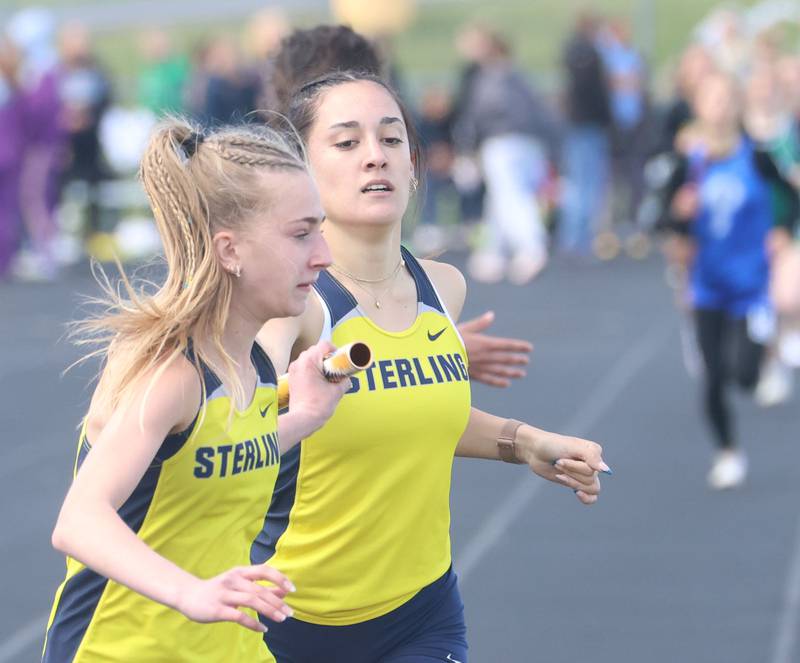 Sterling's Sophia Davis gets the baton from Jaz'Mya Castaneda in the 4x800 relay during the Class 2A Sectional track meet on Wednesday, May 13, 2026 in the Jeff Prusator Athletic Complex at Mendota High School.
