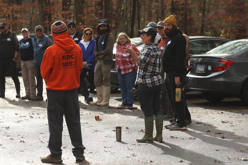 Carol Goolsby, volunteer for Friends of Illinois Nature Preserves, gives details to volunteers for the nature preservation event to restore light to the woodland floor in Pilcher Park on Sunday, Nov. 10, 2024 in Joliet.