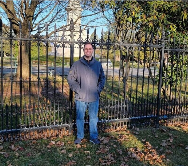 Woodland teacher Matthew Phillips stands on the exact spot where Lincoln would have stood on Nov. 19, 1863, while delivering the “Gettysburg Address.” An arced platform would have been on the site and Lincoln would be facing towards the National Soldiers’ Memorial (background), which was not present at the time of Lincoln delivering the speech.