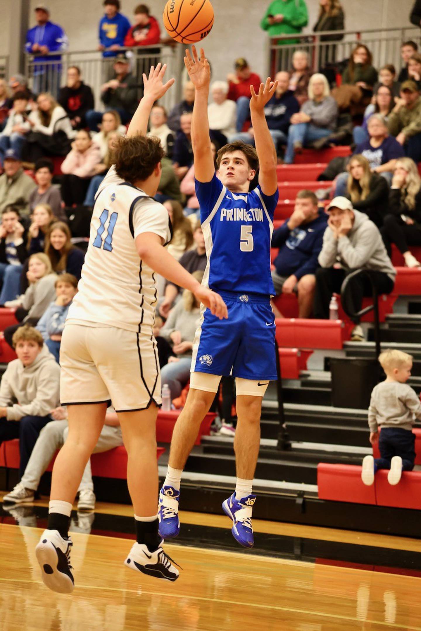 Princeton's Jack Oester shoots over Bureau Valley's Blake Foster in Saturday's Colmone Classic action at Hall High School. The Tigers won 86-83 in double overtime.