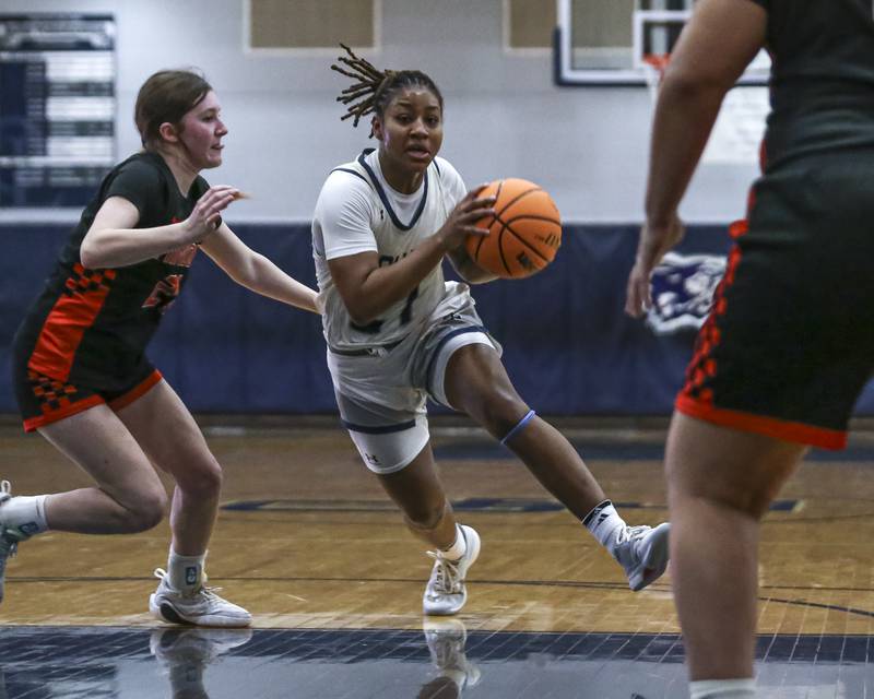 Oswego East's Desiree Merritt (21) drives down the lane before pulling up for a jumper during their basketball game between Minooka at Oswego East Friday, Jan 16, 2026 in Oswego.