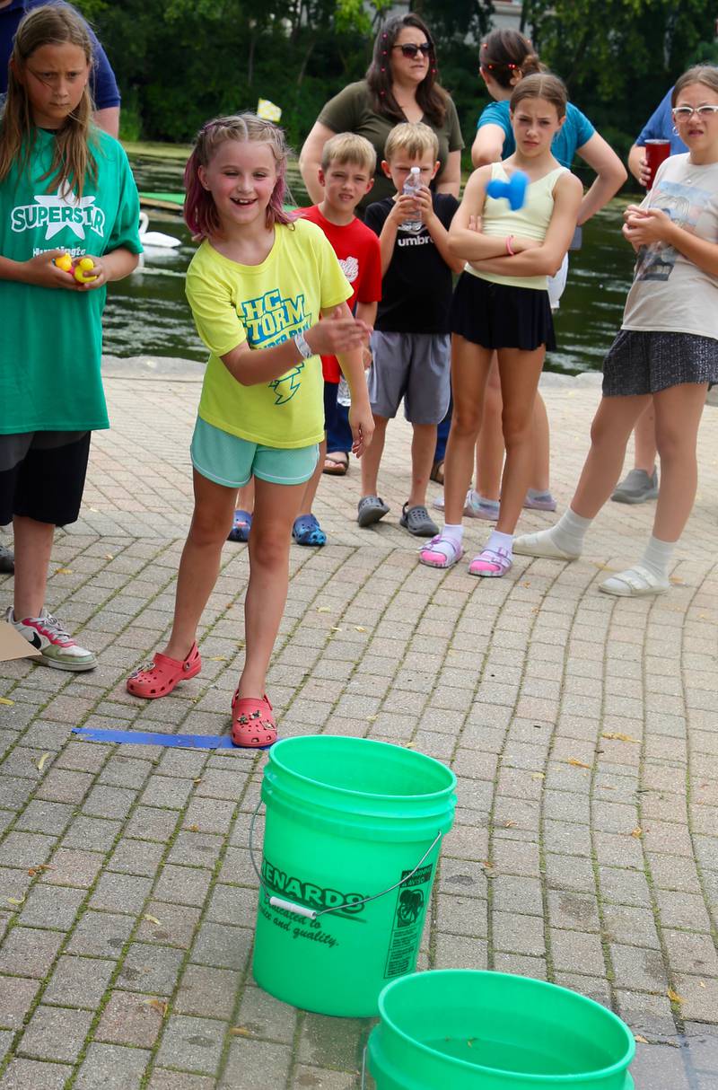 Nine-year-old Evelyn Smith of Batavia participates in the Chuck the Duck Toss at the Windmill City Festival in Batavia on Saturday, July 13, 2024 in Batavia.