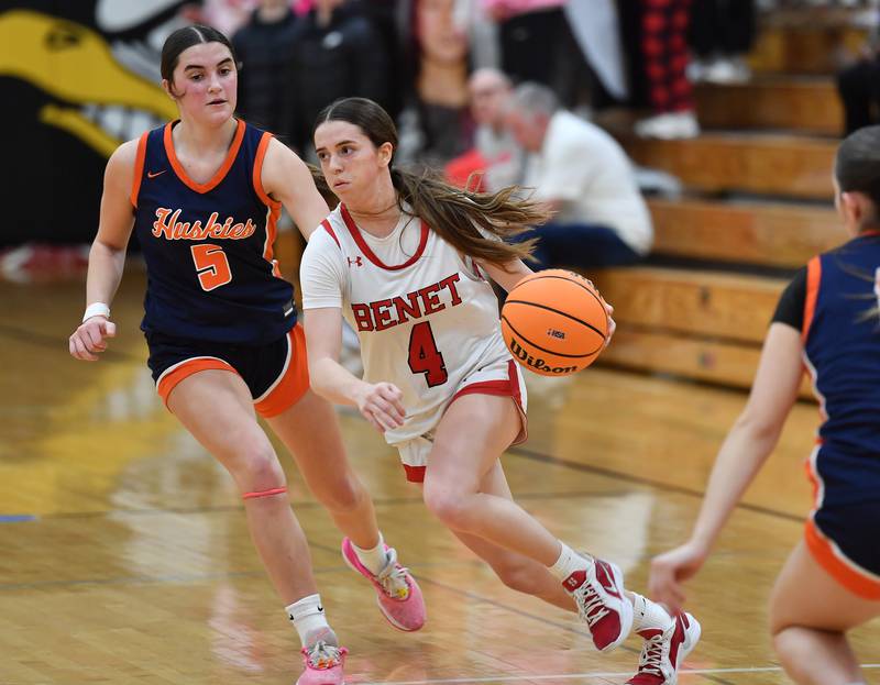 Benet’s Ava Mersinger (4) drives past Naperville North’s Ava Podkasik (5) during the Class 4A Benet Regional championship game on February 20, 2025 at Benet Academy in Lisle.
